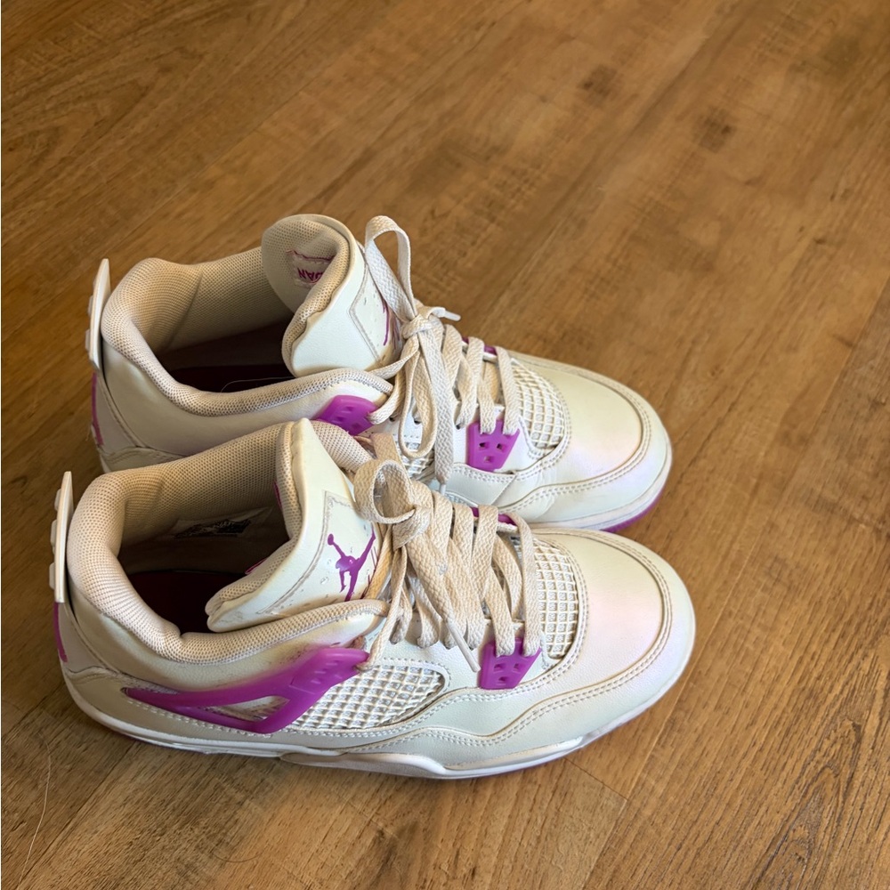 This is a Nike Air Jordan 4 Retro "Hyper Violet" sneaker.